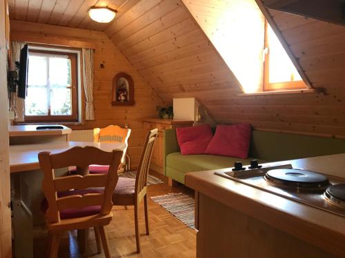 a kitchen and living room with a couch and a table at Appartements Futtertrögl in Lachtal