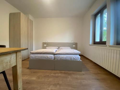 a bedroom with a bed in the middle of it at Vera Park & Wellness in Belluno
