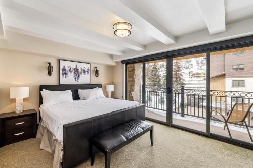 a bedroom with a bed and a balcony at Spacious Luxury Unit at Lionshead Village in Vail in Vail