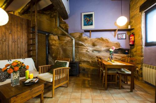 a dining room with a table and a fireplace at Pla del Castell II in Albarca