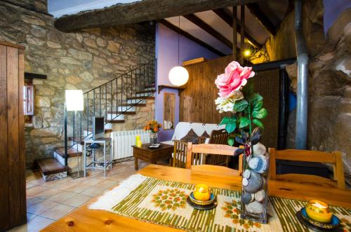 a living room with a table and a stone wall at Pla del Castell II in Albarca