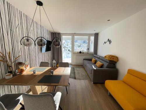 a living room with a couch and a table at Maisonnette am Bikepark Winterberg mit Terrasse Loggia Garage in Winterberg