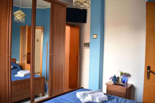 a bedroom with a mirror and a bed at Il Giardino di Vincenzina B&B in Lauria