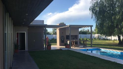 a house with a swimming pool and a pavilion at Maynumbí in San Rafael