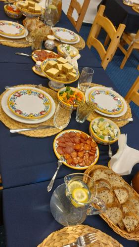 a blue table with plates of food on it at Penzion Sonáta in Luhačovice