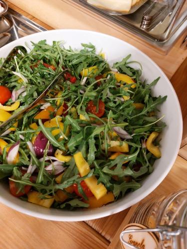 a salad in a white bowl on a table at Penzion Sonáta in Luhačovice
