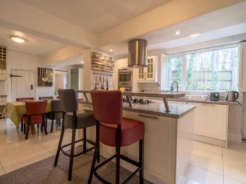 a kitchen with a large island with bar stools at Pass the Keys Beautiful 6 Guest Cottage in Nottingham