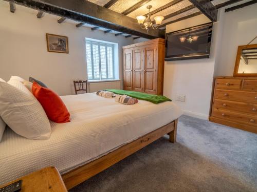 a bedroom with a large bed and a dresser at Pass the Keys Beautiful 6 Guest Cottage in Nottingham
