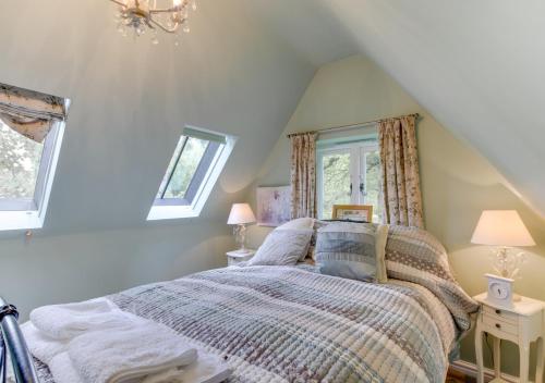 a bedroom with a bed in a attic at Rose Lodge in Yaxham