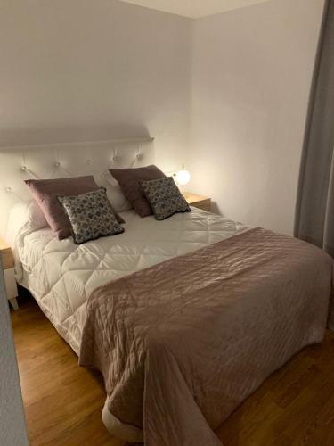 a bedroom with a large bed with two pillows on it at ALOJAMIENTO SARDOY in Murcia