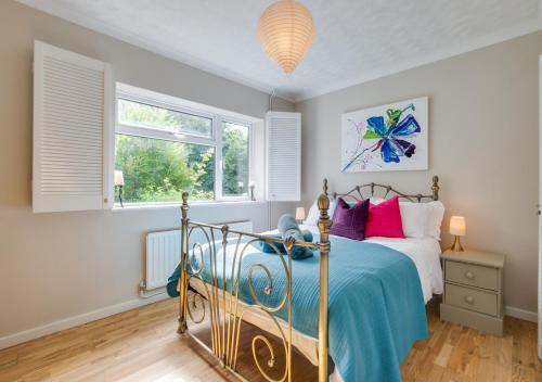 a bedroom with a bed and two windows at Sandy Bottom in Hunstanton
