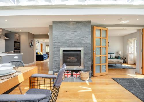 a living room with a stone fireplace in a house at South Way in West Runton