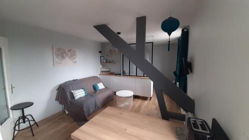 a living room with a couch and a table at Bel appartement, Carnac bourg in Carnac