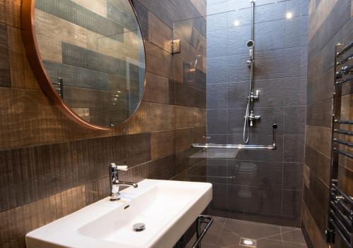 a bathroom with a sink and a mirror at The Cattle Shed in Wighton