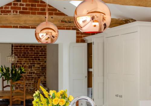 a kitchen with two lights hanging from the ceiling at The Granary in Banningham
