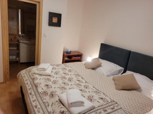 a bedroom with a bed with towels on it at Penzion Sinfonietta in Luhačovice