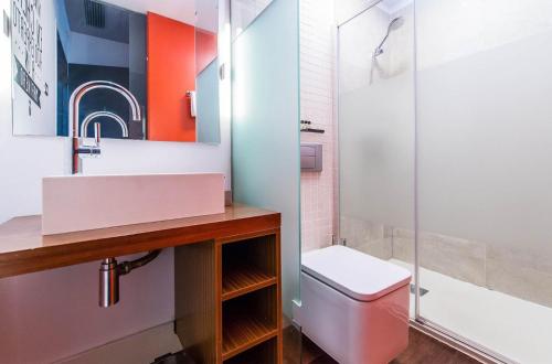 a bathroom with a sink and a toilet and a shower at Sweet Inn - Loft Villa Olimpica Beach in Barcelona