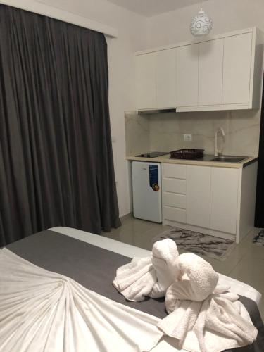 a bedroom with a bed with towels on it at Vila Xhafa in Ksamil