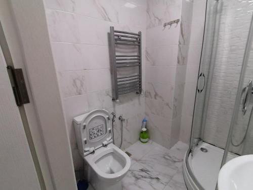 a small bathroom with a toilet and a shower at Квартира in Baku