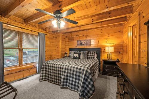 a bedroom with a bed and a ceiling fan at 2-Bedroom Cabin with 2 Master Suites, Loft, Half-Bath and hot tub in a Serene Resort Setting in Sevierville