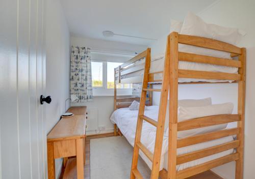 a bedroom with a bunk bed and a desk at The Lookout -Cromer in Cromer