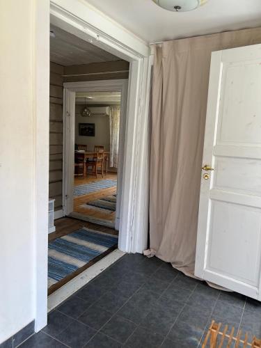 an open door into a room with a dining room at Brännkärrstorpet B&B in Knivsta
