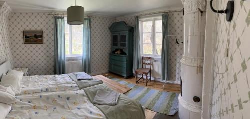 a bedroom with a bed and a desk in it at Brännkärrstorpet B&B in Knivsta