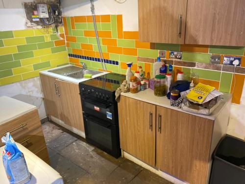 a kitchen with a stove and a sink in it at The Bunker in Manchester