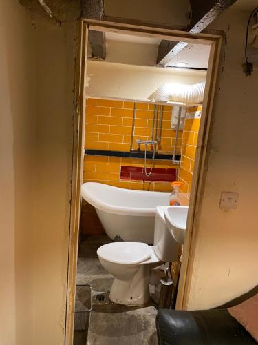 a bathroom with a toilet and a sink at The Bunker in Manchester