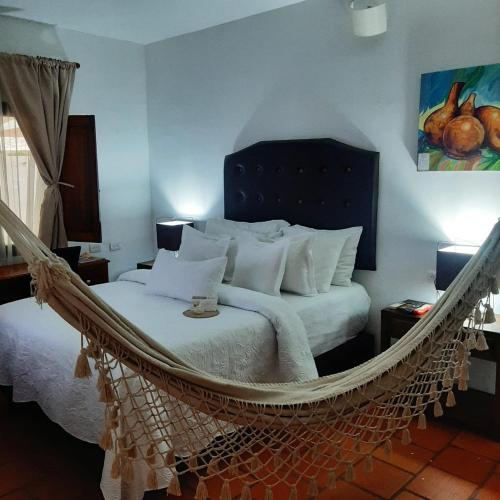 a bedroom with a hammock bed in a room at Hotel Boutique Casa de Los Santos Reyes Valledupar in Valledupar
