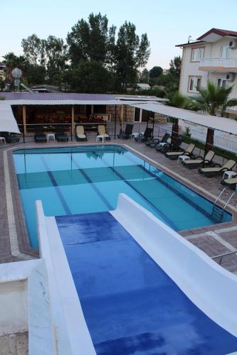 a large swimming pool with blue water at Hotel Gold Stone in Beldibi
