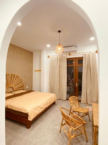 a bedroom with a bed and a chair at VYA homestay Huế in Thôn Lại Thê