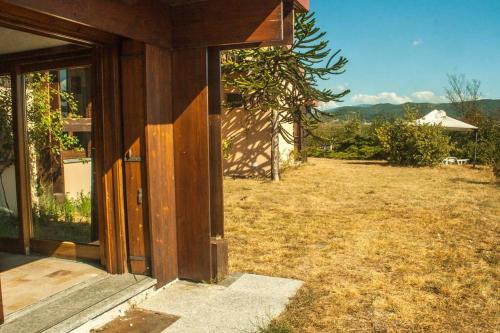 an open door of a house with a yard at Oasi di Mastarone - Il vino e le Rose in Momperone