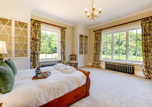 a bedroom with a large bed and two windows at Vere Lodge Garden Wing 