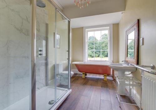 a bathroom with a tub and a shower and a sink at Vere Lodge 
