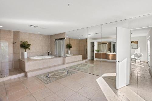 a bathroom with a tub and a shower and a sink at A WFH Resort in Paradise Valley in Scottsdale