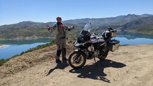 a man standing next to a motorcycle on a dirt road at Hotel Golden Star in Taounate