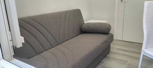 a gray couch sitting in a room at Le vie del centro in Sciacca