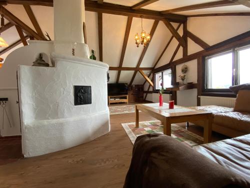 a living room with a fireplace in the middle at Direkt am Hopfensee- Ferienwohnung in Füssen