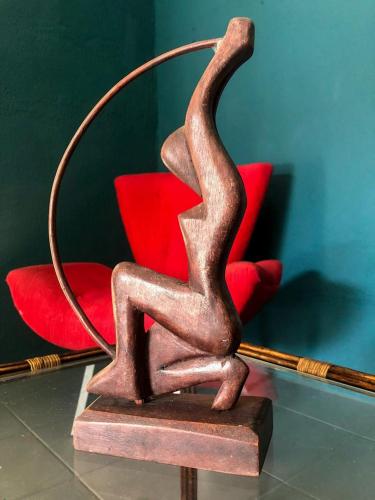 a metal statue of a person sitting on a red chair at Pousada Fortaleza in Fortaleza