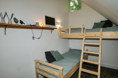 a bedroom with two bunk beds and a desk at Luxe Vakantiehuis Zeeland in Wilhelminadorp