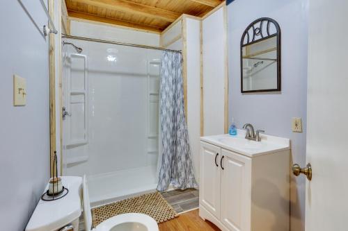 a bathroom with a shower and a toilet and a sink at Dreamy Indiana Cabin Rental with Shared Amenities! in Taswell