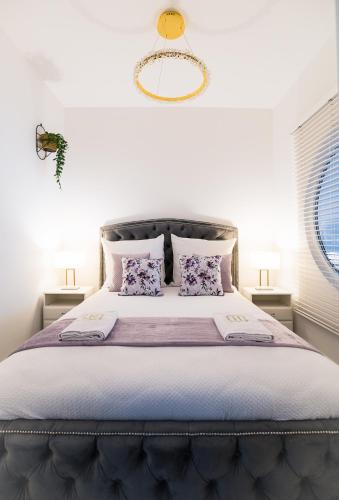 a bedroom with a large bed with purple sheets and pillows at Aquarius Residence Apartament 104 in Boszkowo