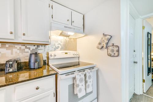 a kitchen with white cabinets and a stove top oven at Walk to Downtown Albany Ten Broeck Triangle Apt! in Albany