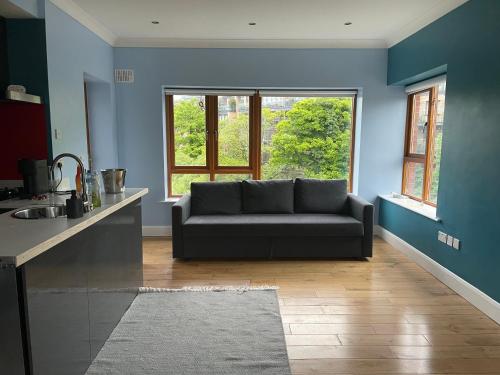 a living room with a couch in front of a window at Serene Riverside Villa - Hidden gem in Dublin City in Dublin