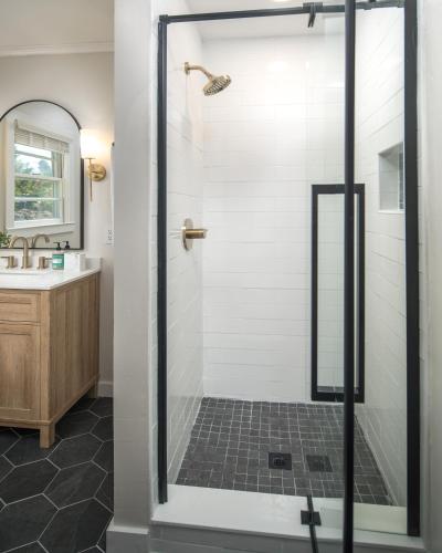 a shower with a glass door in a bathroom at The Victorian Inn Blowing Rock in Blowing Rock