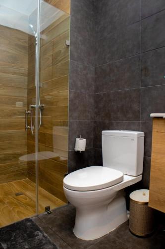 a bathroom with a toilet and a glass shower at Exclusive brand new 3BR condo at Cap Cana in Punta Cana