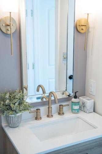 a bathroom sink with a large mirror above it at The Victorian Inn Blowing Rock in Blowing Rock