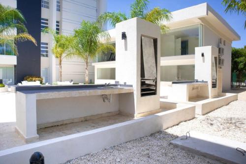 a white house with a sink in front of a building at Exclusive brand new 3BR condo at Cap Cana in Punta Cana