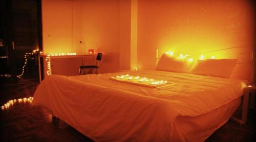 a bedroom with a bed with lights on it at Acropolis View Dream in Athens